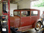 1929 Tudor Sedan being pushed into the shop for disassembly.